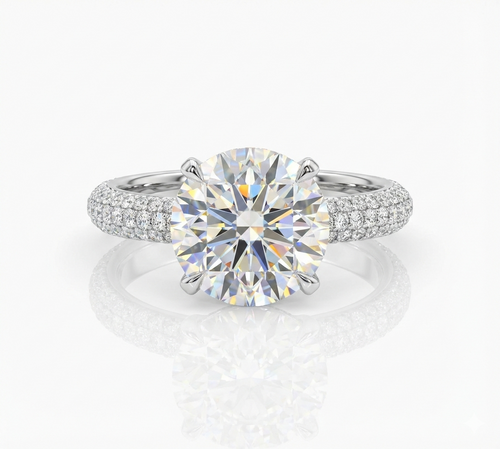 Diamond ring with a large central gemstone and smaller stones on the band against a white background